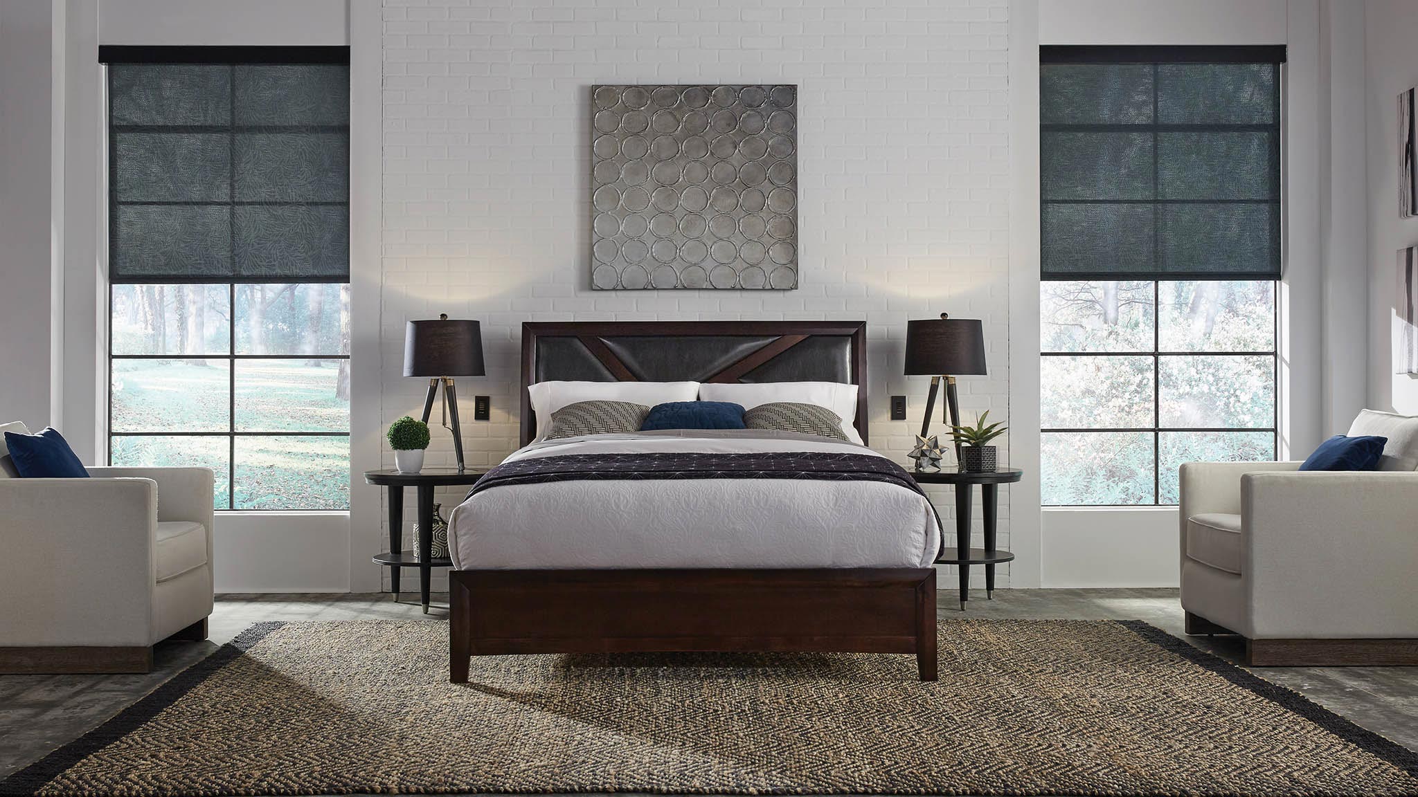 A couple enjoys a cozy living room with automated blinds and modern lighting.