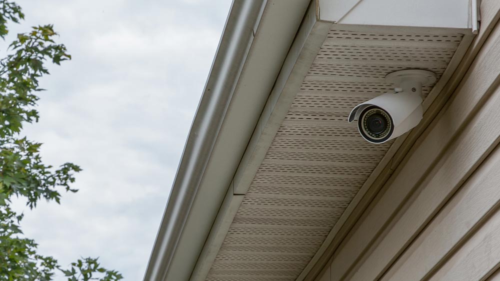 A contemporary kitchen with warm lighting, featuring wooden cabinets, a large island with bar stools, modern appliances, and decorative elements, creating a cozy and inviting space for cooking and dining.